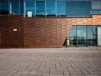 a large building that is made of wood and glass windows a bicycle in the foreground