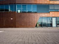 a large building that is made of wood and glass windows a bicycle in the foreground