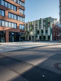 the building has a square shape with many windows and a number of stairs in front of it