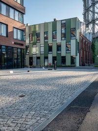 the building has a square shape with many windows and a number of stairs in front of it