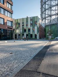the building has a square shape with many windows and a number of stairs in front of it