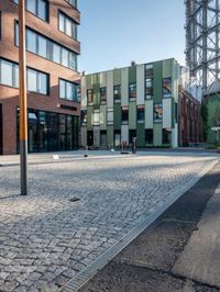 the building has a square shape with many windows and a number of stairs in front of it