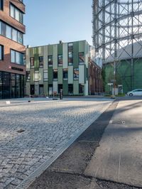 the building has a square shape with many windows and a number of stairs in front of it