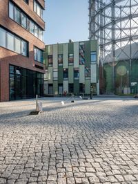 the building has a square shape with many windows and a number of stairs in front of it