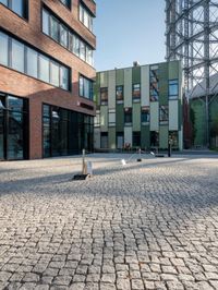 the building has a square shape with many windows and a number of stairs in front of it