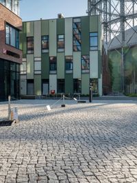 the building has a square shape with many windows and a number of stairs in front of it
