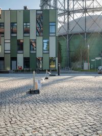 the building has a square shape with many windows and a number of stairs in front of it