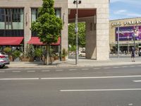 cars and pedestrians are parked at the curb in front of an older office building that is surrounded by modern architecture