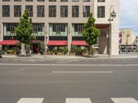 cars and pedestrians are parked at the curb in front of an older office building that is surrounded by modern architecture