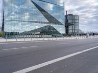 this is an image of a big building that is reflective glass and is reflecting another building