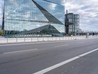 this is an image of a big building that is reflective glass and is reflecting another building