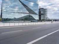 this is an image of a big building that is reflective glass and is reflecting another building