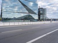 this is an image of a big building that is reflective glass and is reflecting another building