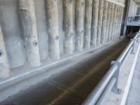 the floor area of a large water storage with a small pipe coming out of it