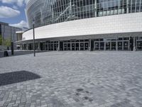 a large building with a lot of glass windows on the outside of it with the sun shining