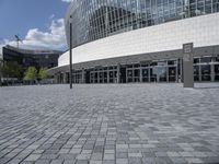 a large building with a lot of glass windows on the outside of it with the sun shining