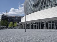 a large building with a lot of glass windows on the outside of it with the sun shining