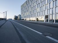 a street that has some buildings on it next to some concrete pillars and a small fire hydrant