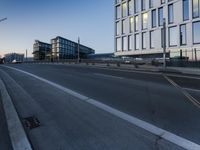 a street that has some buildings on it next to some concrete pillars and a small fire hydrant