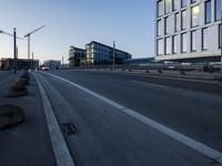 a street that has some buildings on it next to some concrete pillars and a small fire hydrant