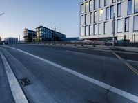 a street that has some buildings on it next to some concrete pillars and a small fire hydrant
