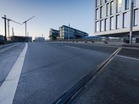a street that has some buildings on it next to some concrete pillars and a small fire hydrant