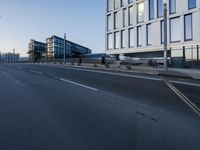 a street that has some buildings on it next to some concrete pillars and a small fire hydrant