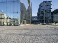 a black fire hydrant sitting in front of a glass building in europes capital