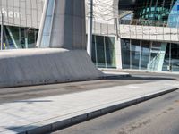 a skateboarder is on the sidewalk in front of an office building in europe