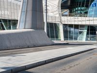 a skateboarder is on the sidewalk in front of an office building in europe