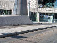 a skateboarder is on the sidewalk in front of an office building in europe