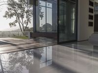 there are many steps on the ground by this house that has two large glass doors