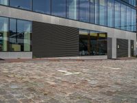 there is a yellow frisbee on the pavement outside a building with a large glass window