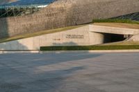 a stone building has a modern style architecture in it's centerpiece, as seen from the plaza