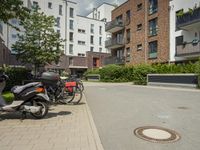 motor scooters are parked next to the street in front of a building area