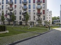 an empty street with some modern buildings and small parks near it for recreation and privacy