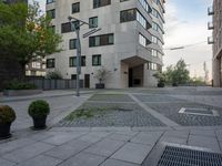 a building is outside, with some trees and other plants around it's courtyard