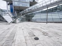 several stairs inside of some glass building with a person taking a picture with their camera