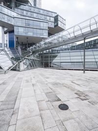 several stairs inside of some glass building with a person taking a picture with their camera