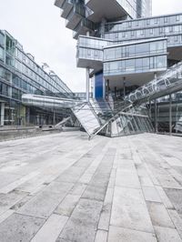 several stairs inside of some glass building with a person taking a picture with their camera
