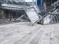 several stairs inside of some glass building with a person taking a picture with their camera