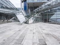 several stairs inside of some glass building with a person taking a picture with their camera