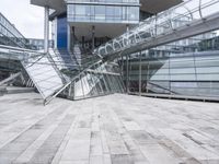 several stairs inside of some glass building with a person taking a picture with their camera