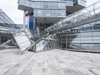several stairs inside of some glass building with a person taking a picture with their camera