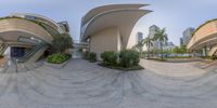 a fish eye lens shot of a building in the middle of the cityscape