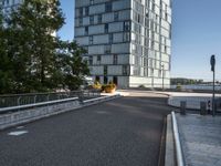 the view from an area that contains many buildings and an overpass with plants, along with trees