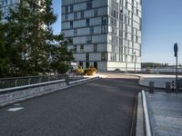 the view from an area that contains many buildings and an overpass with plants, along with trees