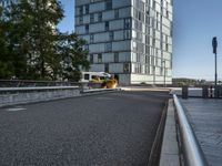 the view from an area that contains many buildings and an overpass with plants, along with trees