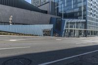 a city street lined with tall buildings and parked cars by a street curb covered in glass