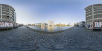 a 360 view of a river and buildings in a city with water on one side